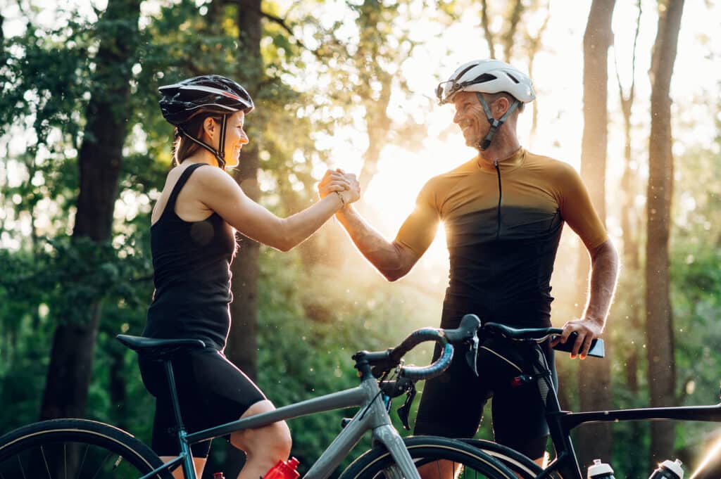 Couple getting ready for a race on their bicycles 